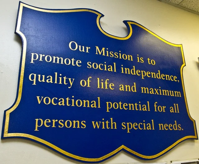 CVR mission statement sign with gold text on a blue plaque.